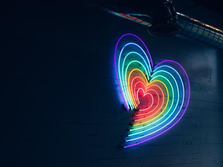 A rainbow heart in neon lights.