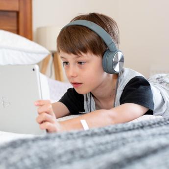 Child using a tablet with headphones
