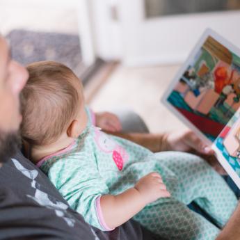 Father reading to small child with a picture book