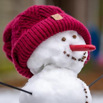 Snowman with a red knit hat.