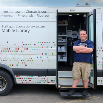 Bryan poses next to the BCLS Mobile Library