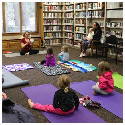 A group practices yoga during storytime at the Riverton Library