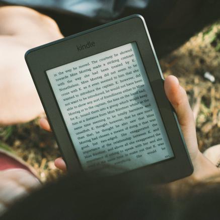 A reader holds a Kindle device