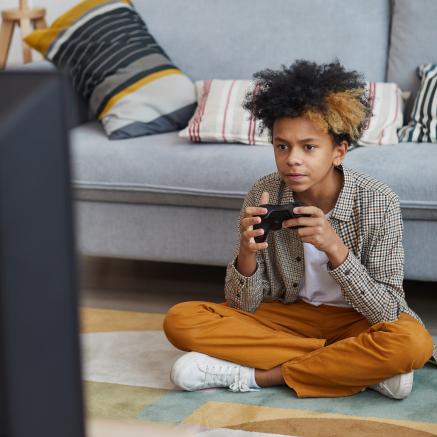Young boy playing with a video game controller