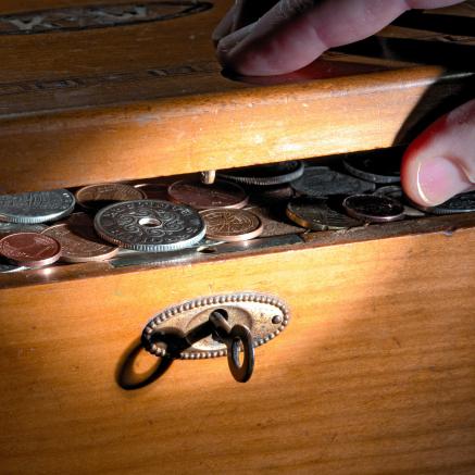A chest is unlocked to reveal a collection of coins.