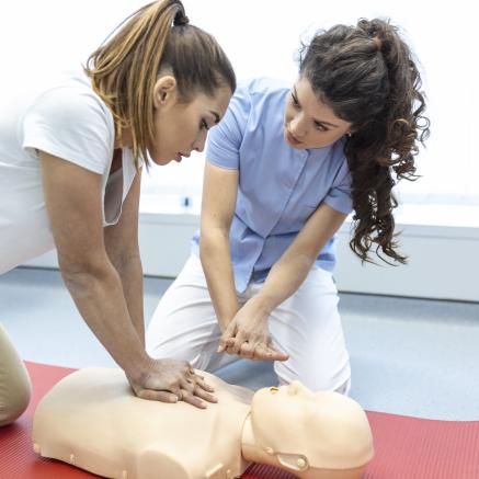 Two women doing CPR training