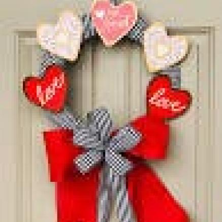 Wreath made of paper hearts with red ribbon bow