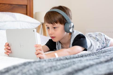 Child using a tablet with headphones