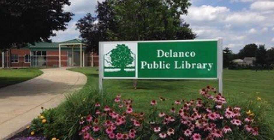 Image of Delanco Public Library's front sign with flower bushes
