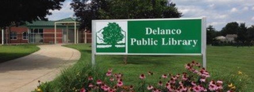Image of Delanco Public Library's front sign with flower bushes