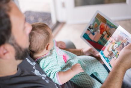 Father reading to small child with a picture book