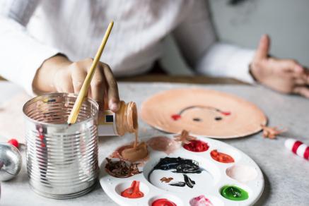 Child painting on a paper plate