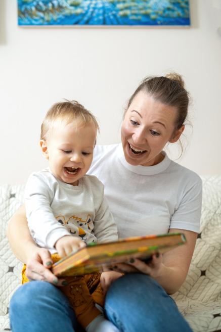 Woman reading to a baby on her lap