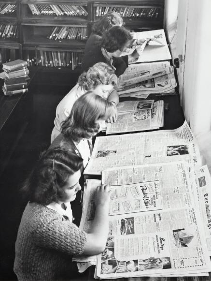 Librarians read the newspaper