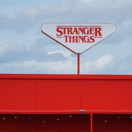 A store sign bears the logo for the Netflix show, Stranger Things.