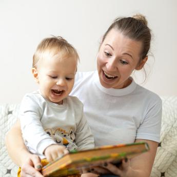 Woman reading to a baby on her lap