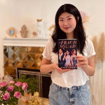 Author Kyla Zhao holds her book, The Fraud Squad.