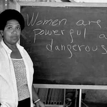 Audre Lorde with a chalkboard that says: Women are powerful and dangerous